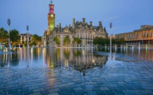 Colourful clock tower reflecting in water - representing broadband in Bradford