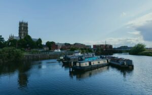 Boats on calm river with buildings - representing broadband in Doncaster