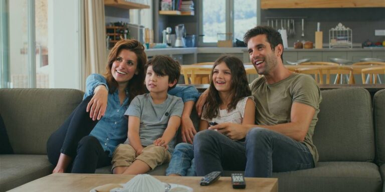 Family on sofa watching tv representing Broadband Speed For Streaming