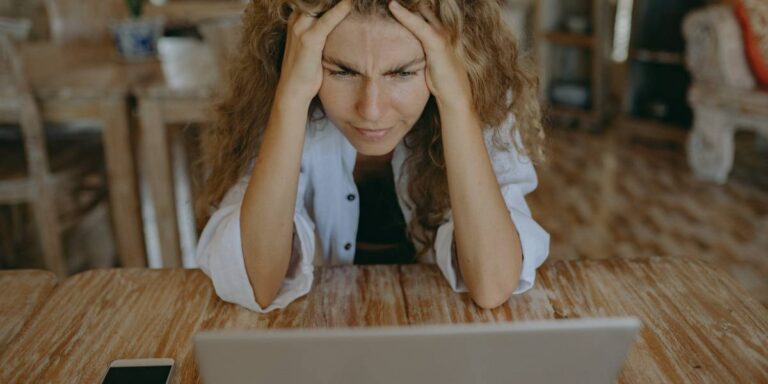 Lady frustrated at laptop representing Broadband outage