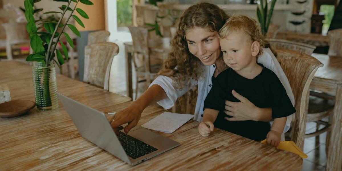 Parent and child at laptop - representing parental controls for broadband